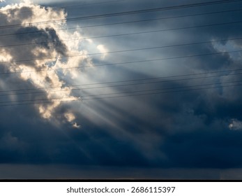Sunbeams break through the dark cloudy sky