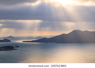 Sunbeams Breaking Through Clouds Over Serene Ocean