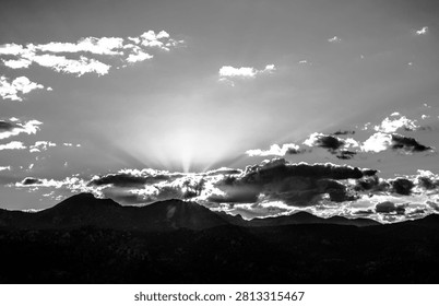 Sunbeams breaking through clouds over mountains