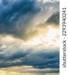 Sunbeams breaking through dramatic cumulus clouds. Weather change from stormy to sunny. Hope or religion concept.