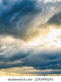 Sunbeams breaking through dramatic cumulus clouds. Weather change from stormy to sunny. Hope or religion concept.