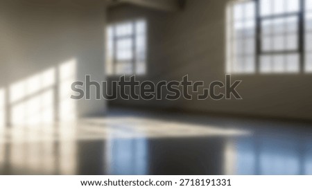 Sunbeams flood empty loft space with industrial windows.