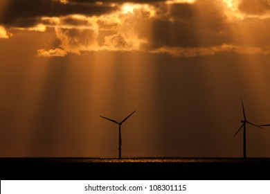 Sunbeams Over A Wind Farm Offshore Llandudno North Wales UK