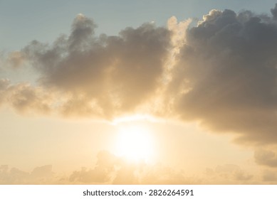 The sunbeams pierce through dramatic clouds during a vibrant sunset over the sea, casting a warm golden glow across the sky. This atmospheric scene evokes peace and natural beauty. [Location unspecified], [Country unspecified].