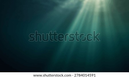 Sunbeams pierce through the surface of deep, dark blue-green ocean water, casting visible light rays into the mysterious and serene underwater environment.