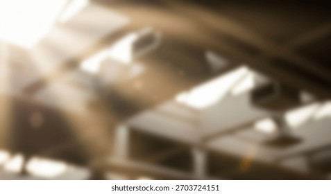 Sunbeams through structures with blurred architectural background.