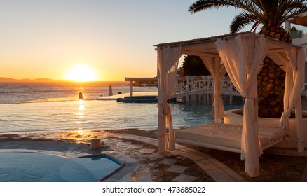 Sunbed And Infinity Pool At Sunset