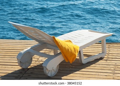 Sunbed Near The Sea With A Yellow Towel