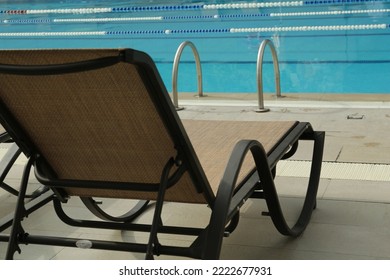 Sunbed near swimming pool at luxury resort