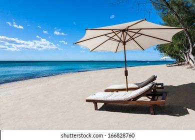 Sunbed and umbrella on a beautiful tropical beach