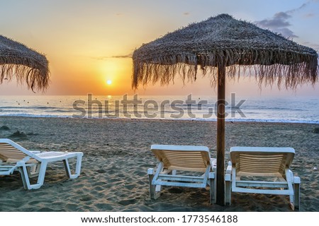 sunbed and umbrella on the sunset background, Torremolinos, Spain