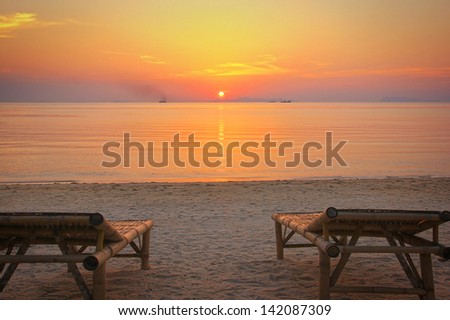 Sunbeds on the beach at sunset