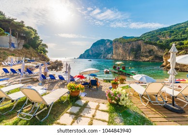 Sunbeds And Umbrella On The Beach In Corfu Island, Greece.