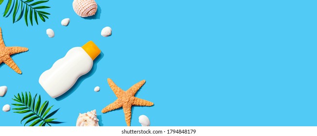 Sunblock Bottle With Starfish And Seashells - Flat Lay