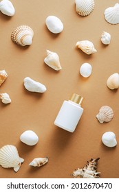 Sunblock Cream Lotion Bottle And Seashells On Sandy Color Background. Flat Lay, Top View, Overhead.