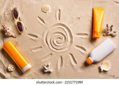Sunblock lotion tubes and sunglasses on sandy beach background. Summer vacation and skin care concept, sunscreen products, spf uv-protect cosmetics.