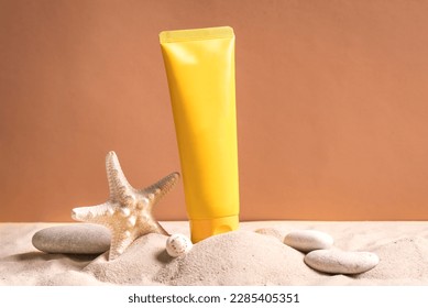 Sunblock in orange cosmetic tube on beach sand and beige background, side view. Summer vacation and skin care concept with starfish and sea shells, spf uv-protect cosmetics. - Powered by Shutterstock