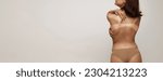 Sunburn marks. Back view image of slim woman, girl with swimwear tan line over light studio background. Sun protection cosmetics. Concept of health, spf, sunscreen lotion, vacation, summer, ad