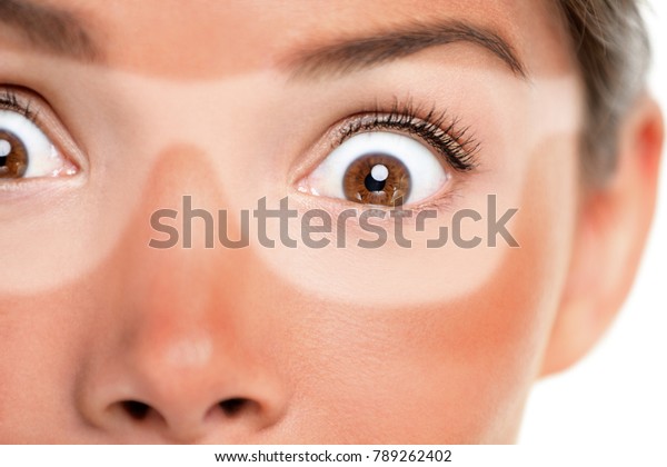 Sunburn tan lines of sunglasses, red painful\
skin. Scared Asian woman shocked with funny expression forgot to\
put sunscreen on face on summer vacation. Suntan skin cancer facial\
care concept.