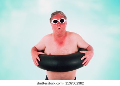 Sunburned man with sunglasses and inner tube - Shutterstock ID 1139302382