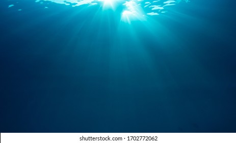 Sunburst On Surface Of Blue Underwater Ocean 