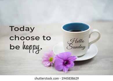Sunday inspirational quote -  Today choose to be happy. With hello Sunday greeting on cup of morning coffee and purple orchid daisy flowers on white table background. Happy Sunday weekend concept.
