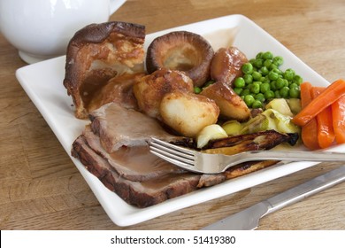 Sunday Roast Dinner On An Old Wooden Table