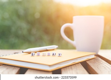 Sunday written in letter beads and a coffee cup on table
