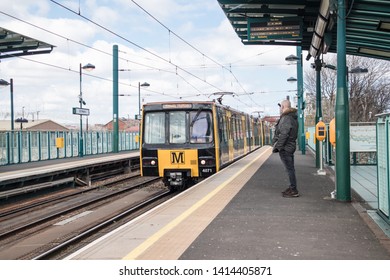 Sunderland - Great Britain / April 13, 2019 : Metro Light Rail Train Pulling Into Station Showing South Hylton On Front.  Man Waiting On Platform