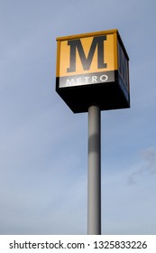 Sunderland / Great Britain - February 19,2019: Metro Sign On A Tall Pole With The Sky Behind It.  Tyneside Metro Light Rail Network In North East England