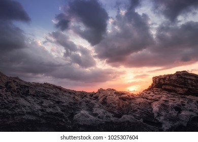 Sundown with clouds and rocks