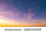Sundown cloudscape. Fluffy clouds in the sunset of dark blue - pink - orange sky. Beautiful daybreak. Dreamy evening