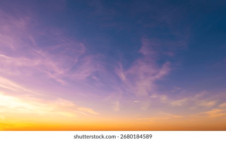 Sundown cloudscape. Fluffy clouds in the sunset of dark blue - pink - orange sky. Beautiful daybreak. Dreamy evening
