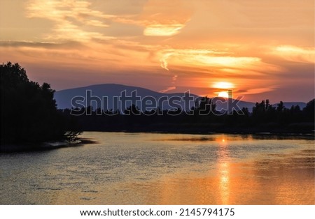 Sundowning over the river in the forest. Sundowning on mountain hill