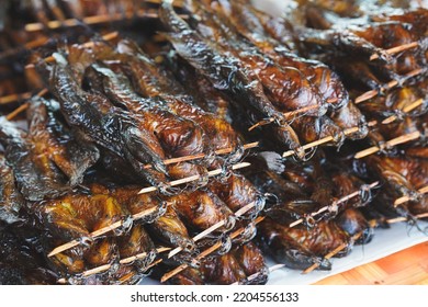 Sun-dried catfish skewers stacked on top of food stalls. Thai traditional food.