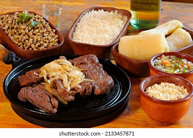 sun-dried meat with beans, rice, farofa, cassava and vinaigrette. Carne de sol. Typical dish from the Brazilian northeast. - Shutterstock ID 2133457871