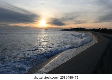 Sunfall with waves on a wall