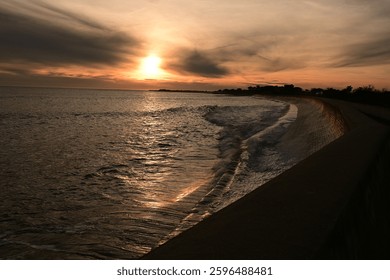 Sunfall with waves on a wall