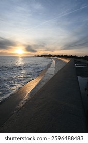 Sunfall with waves on a wall