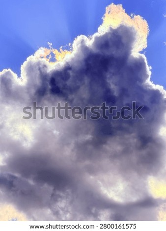 Sunfire brewing behind stormy clouds 