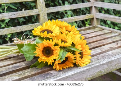 Sunflower Bouquet On Wooden Garden Bench.