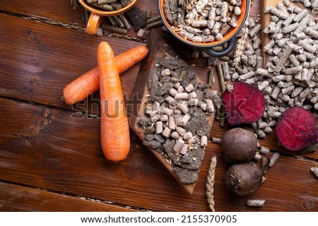 sunflower cake flakes,   grass, beetroot  and bran granules and cereals, fresh beetroots and carrats  for horses and other domestic animalsl. food concept. flat lay