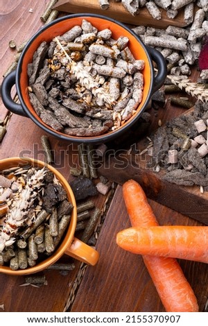 sunflower cake flakes,   grass, beetroot  and bran granules and cereals, fresh beetroots and carrats  for horses and other domestic animalsl. food concept. flat lay