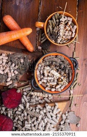 sunflower cake flakes,   grass, beetroot  and bran granules and cereals, fresh beetroots and carrats  for horses and other domestic animalsl. food concept. flat lay