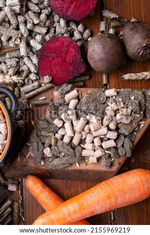 sunflower cake flakes,   grass, beetroot  and bran granules and cereals, fresh beetroots and carrats  for horses and other domestic animalsl. food concept. flat lay