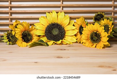 Sunflower Inflorescences Of Different Sizes Are Arranged In A Row On A Surface Of Natural Light Wood And Wooden Slats, Pine Texture, Horizontal, Close-up,side View, Copyspace