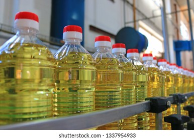 Sunflower oil in the bottle moving on production line in a factory