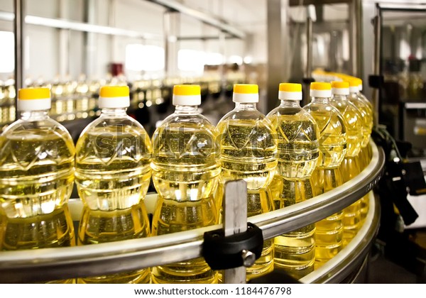 Sunflower oil in the bottle moving on production\
line. Shallow dof.