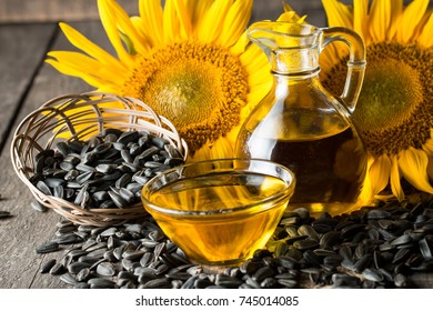 Sunflower oil and sunflower seeds in small sack on traditional rustic wooden background. Organic and eco food concept. Healthy food and fats.