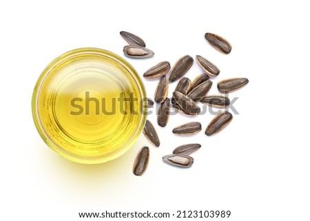 Sunflower seed oil and fresh organic sun flower seeds isolated on white background. Top view. 
